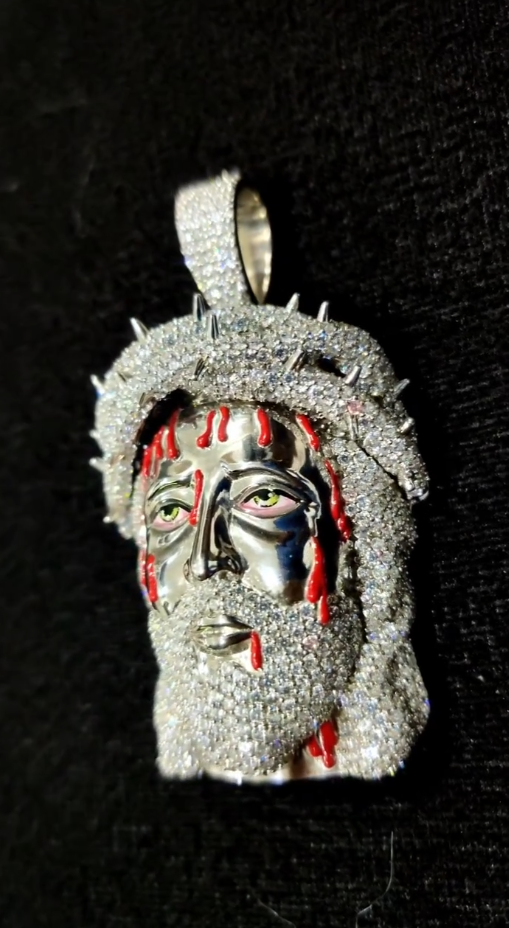 Silver Jesus face pendant adorned with round diamonds