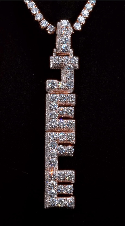 Close-up of the JEFE pendant with sparkling round and baguette-cut diamonds, showcasing VVS1 clarity