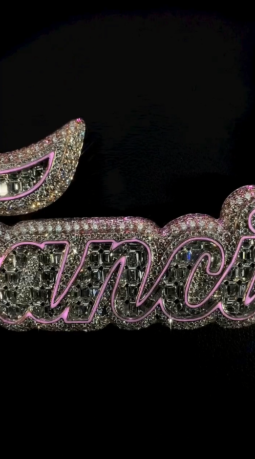 Close-up of iced stones on gold and silver pendant, custom hip hop design with round cut diamonds