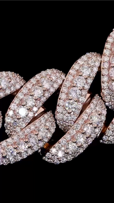 Angled image of rapper-style 22mm Cuban chain, iced links reflecting light.