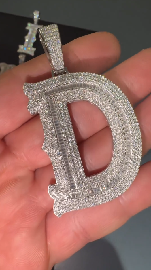 Close-up of the 'D' pendant, showcasing sparkling round-cut Moissanite diamonds and fine craftsmanship