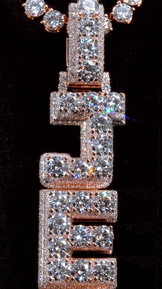 Zoomed-out view of the JEFE letter pendant, emphasizing its luxurious iced-out style and bold lettering
