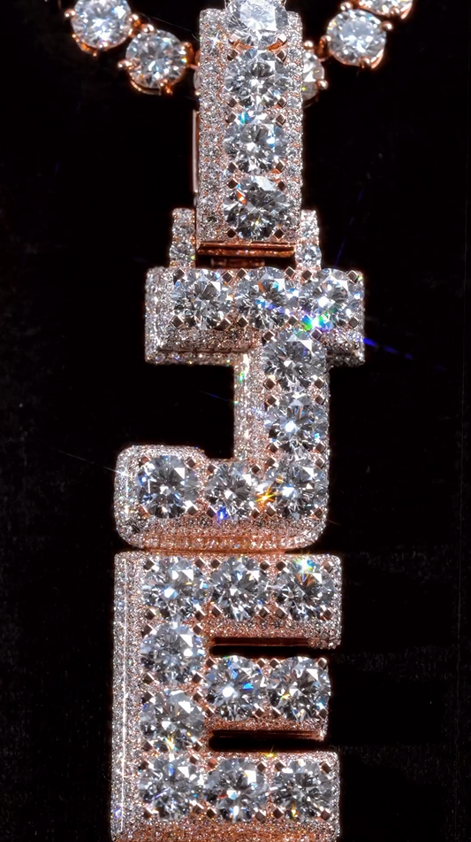 Zoomed-out view of the JEFE letter pendant, emphasizing its luxurious iced-out style and bold lettering