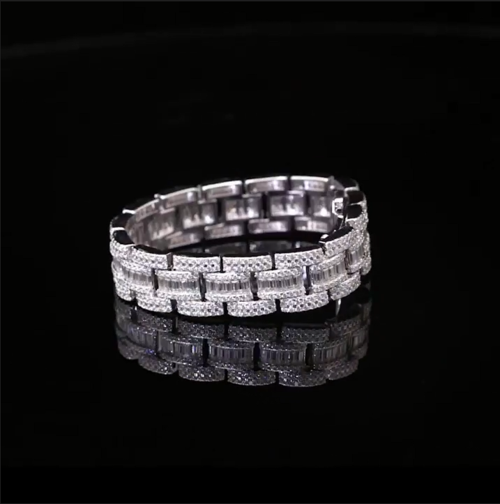 Angled shot of iced 18mm Cuban bracelet, moissanite shine on bold silver link design