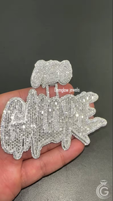 Close-up of iced-out silver name pendant, handcrafted in 925 silver with sparkling diamond accents