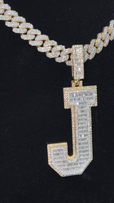 Angled view of the J pendant paired with a Miami Cuban chain, capturing its bold 2-tone design
