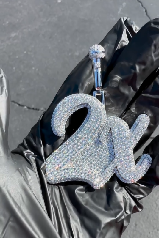Zoomed-out view of the '2X' pendant, highlighting its elegant design and hip-hop-inspired style