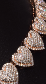 Custom hip hop pendant with heart style iced-out chain, displayed for unisex gifting or couples
