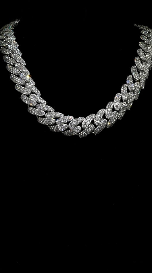 Silver Jesus pendant paired with a Cuban chain, featuring round and marquise diamond detailing