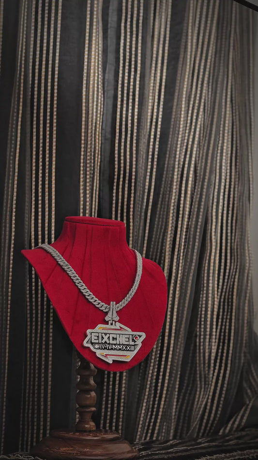 Video of iced-out EIXCHEL pendant with colorful accents, Roman numerals, and Cuban chain